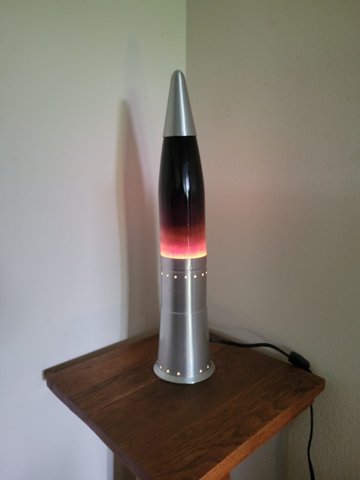 A vintage purple and orange glitter lava lamp — the dual-glitter formula is rare and the color combo is peak psychedelic 70s cool.