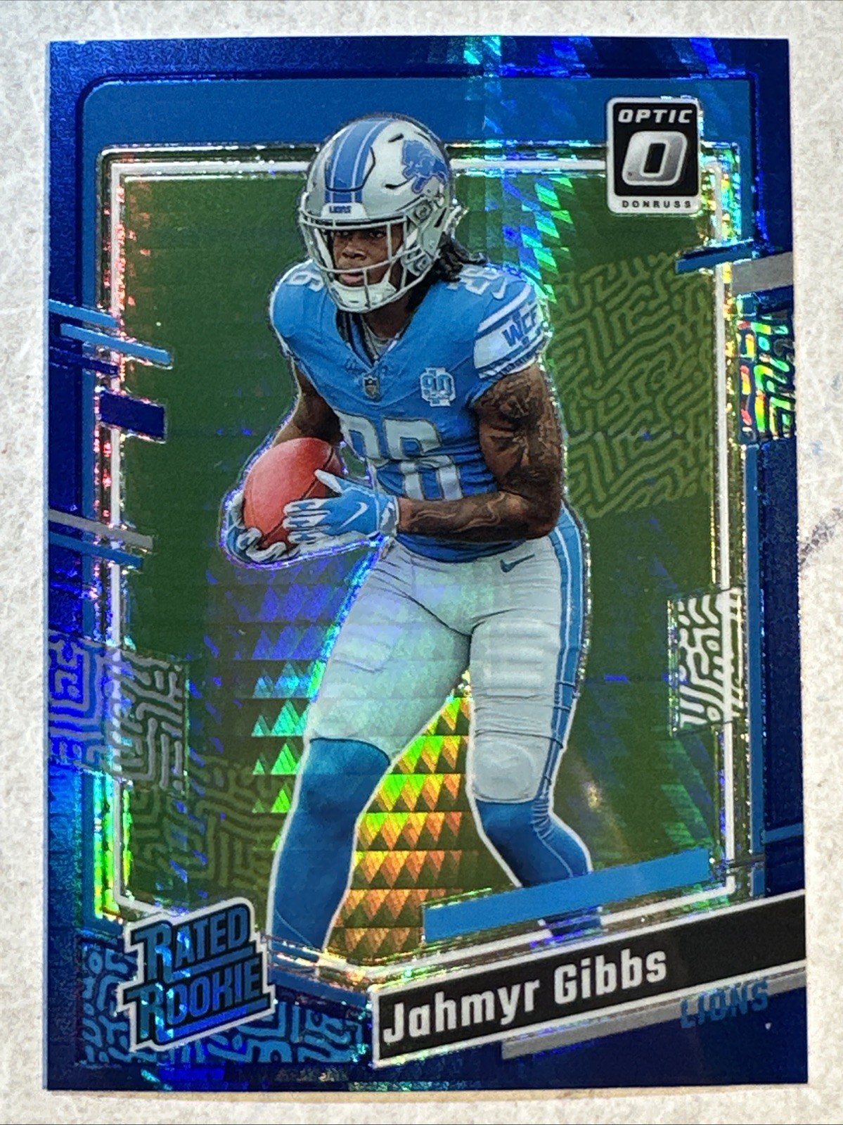 2023 Panini Donruss Optic Jahmyr Gibbs Rated Rookie Blue Hyper Prizm #236 Lions