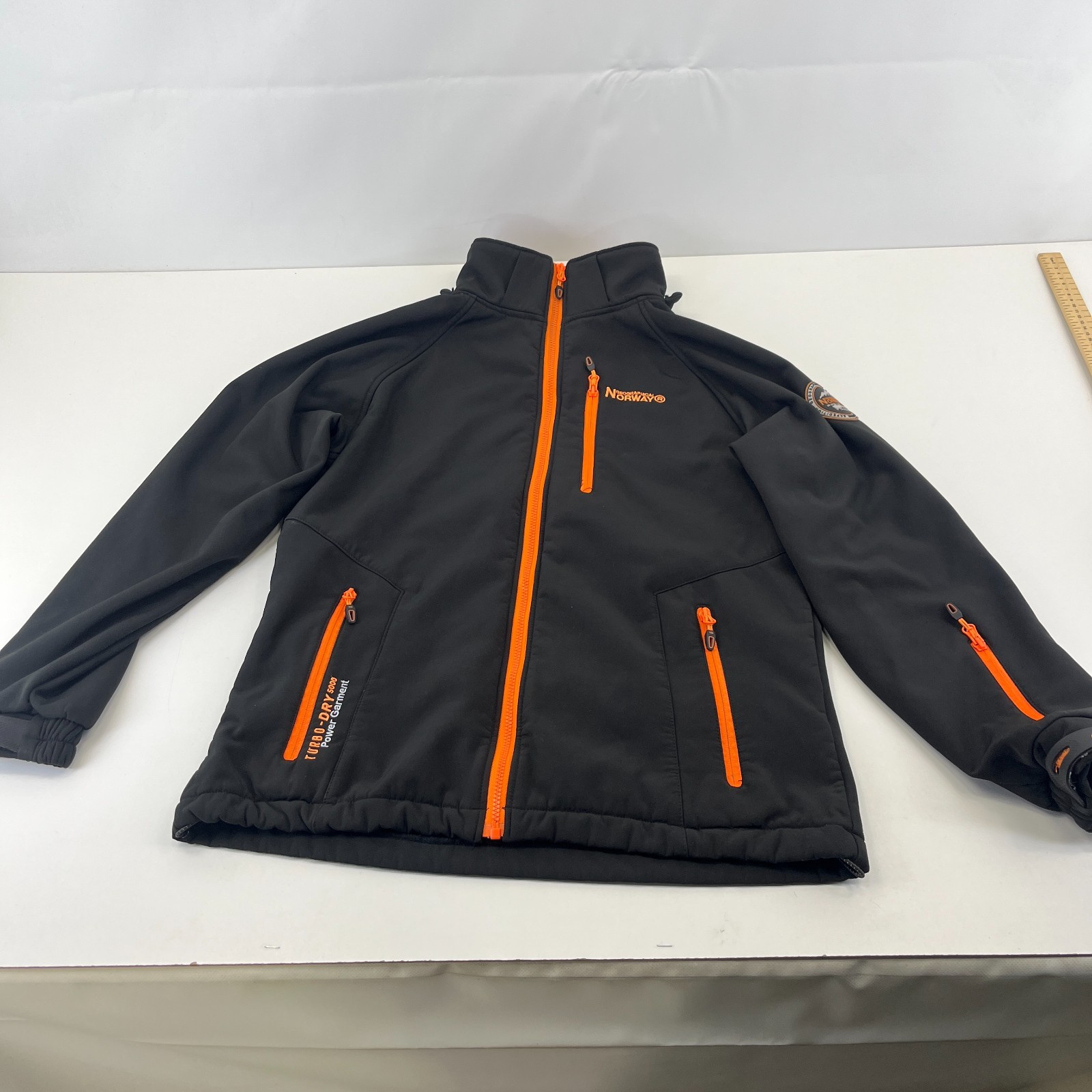 Chaqueta softshell Geographical Norway para hombre en negro y naranja talla grande del Reino Unido
