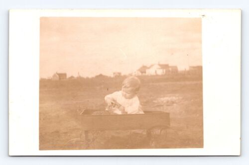 Postcard Baby Boy  Playing in a Wagon RPPC Photo Early 1900s Infant Old Toy - Afbeelding 1 van 2