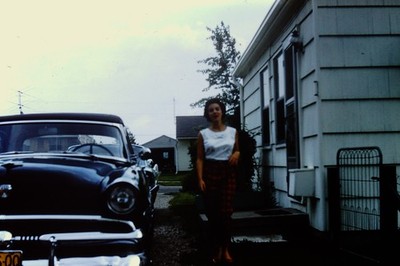Vintage slide photo Classic Car and Woman Standing by House in Overcast Weather