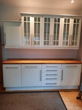 Kitchen Units with wood work top and matching wall cabinets arranged as dresser