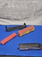 collection of model train cars and a locomotive
