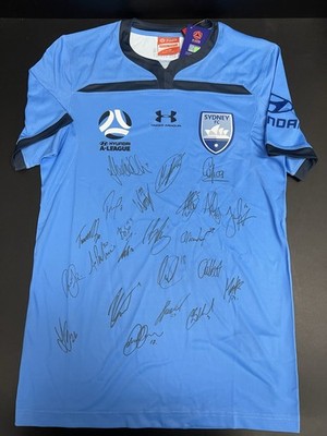 SYDNEY FC A LEAGUE OFFICIAL UNDER ARMOUR SQUAD SIGNED JERSEY - 