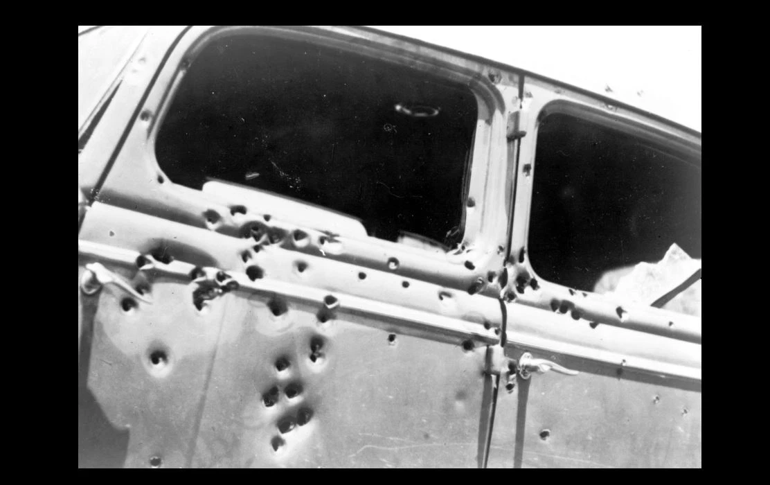 Bullet Holes In Black Car