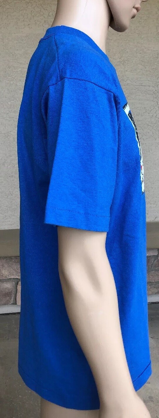 Blue EUC vintage 1995 90s POW MIA Never Forgotten stamp T shirt with white shoulder graphic and red “50/50 FOTL USA Made” text.