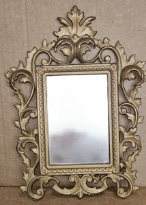 Vintage-style vanity mirror features a gold-finished cast iron frame