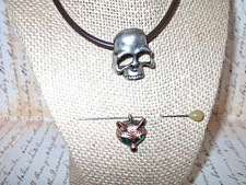 STEEL COLORED METAL SKULL ON LEATHER CHOKER WITH GREEN EYED COPPER WOLF PENDANT