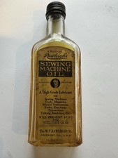 BOTELLA DE VIDRIO EN RELIEVE MÁQUINA DE COSER RAWLEIGH VINTAGE CON ETIQUETA DE PAPEL