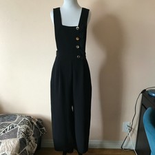 black jumpsuit with gold buttons