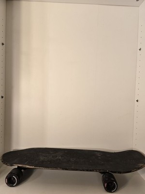Sleek black skateboard with matching black wheels. Pre-Owned