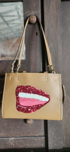 Large Leather Coach Handbag with Bold Red Lips Design-image