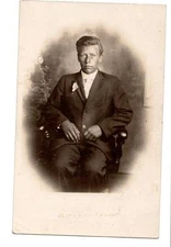 RPPC tanned farmer? boy teen patriotic flag lapel Albro's photo shop Flint,MI
