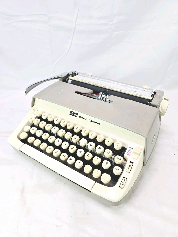 A 1960s Smith Corona Galaxie in cool cream and gray — a clean, stylish manual typewriter that's ready to write the next great novel.
