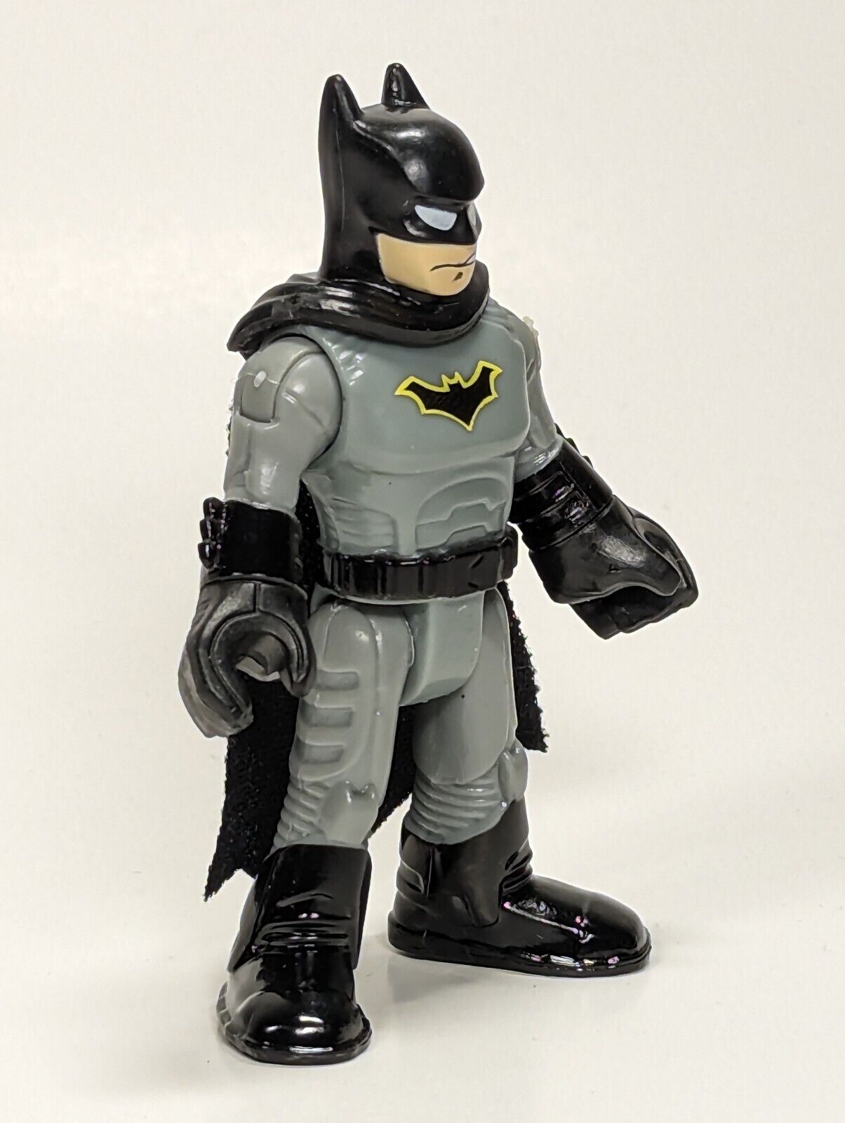 Black and yellow Batman action figure near MacBook Pro photo