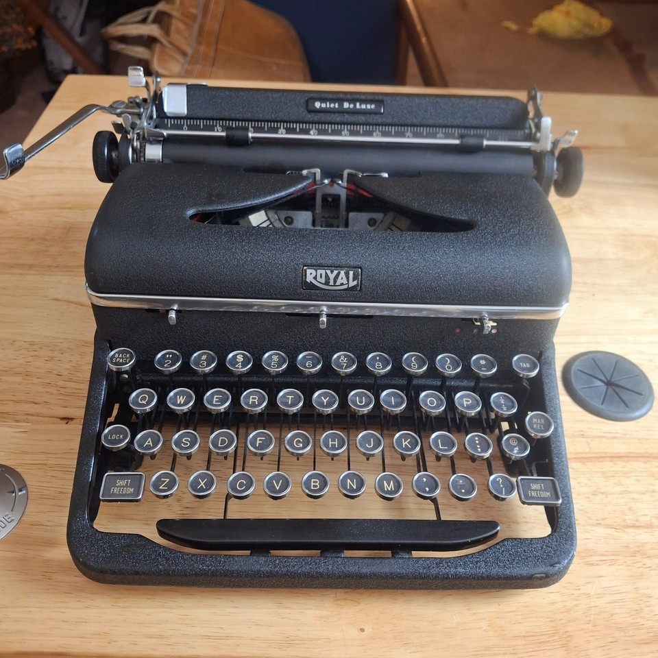 A fully working 1947 Royal Quiet De Luxe — the typewriter Hemingway-era journalists actually used, complete with original case.