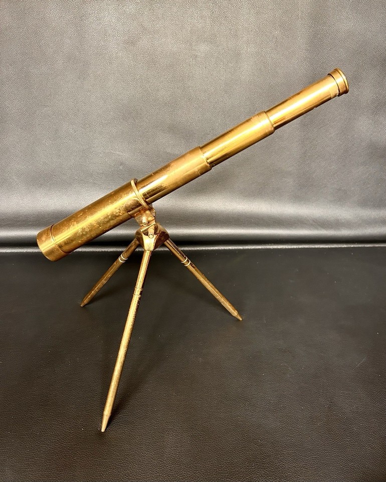 A polished brass tabletop telescope that looks straight out of a Victorian captain's study — functional art for any shelf.