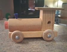 Vintage handcrafted wooden collectible toy train locomotive.