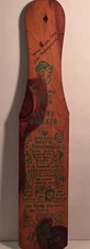wooden novelty spanking paddle with humorous green text and illustrations