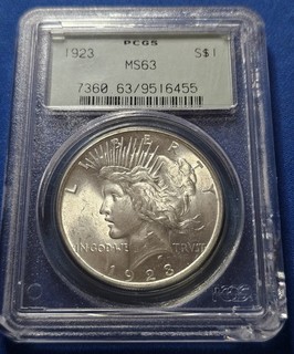 A 1923 Peace Dollar PCGS MS63. Beautiful Coin OGH. Chipped Slab