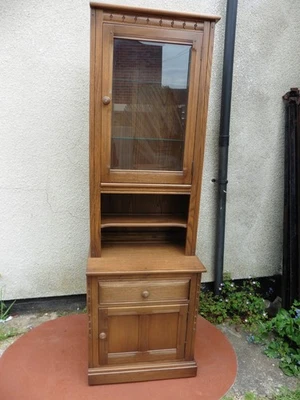 ERCOL GOLDEN DAWN TALL NARROW CABINET, GLAZED TOP, CUPBOARD BASE, TWO PARTS. - Image 1 of 4