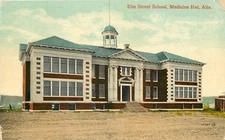 Medicine Hat AB~Dirt Road Past Colonial Elm Street School~c1910 Postcard