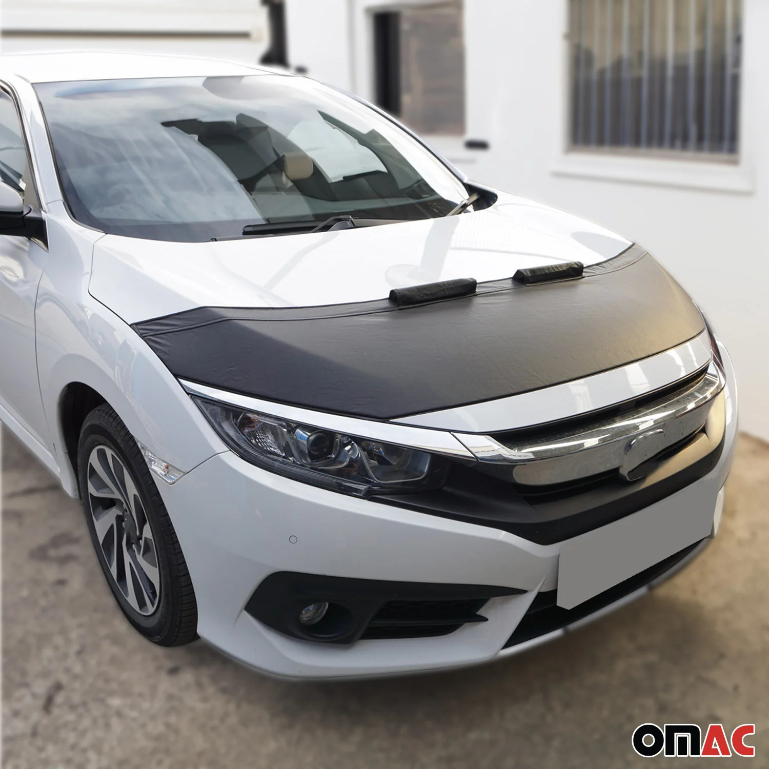 Black car bonnet mask hood bra for VW Touareg 2004-2010 with silver front grille and side vents, OMAC branding on white hood.