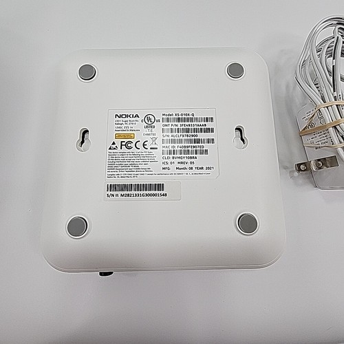 White Eero 6+Plus dual band mesh WiFi router with black top, yellow circle graphic, and printed specifications label.