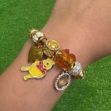 Gold and yellow Winnie the Pooh charm bracelet.