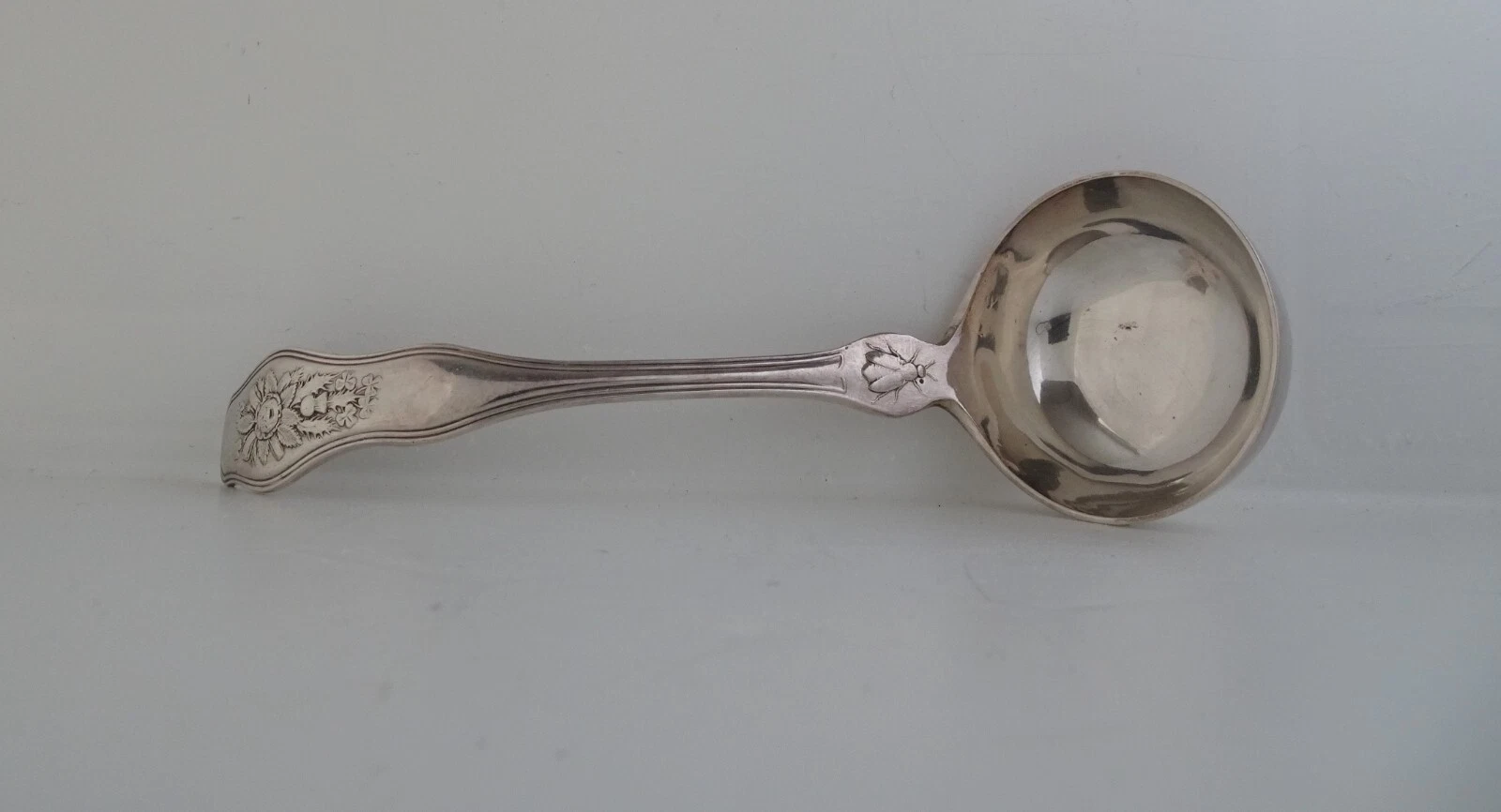 Silver plated sauce ladle with intriguing symbolism