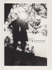 Sunlit Silhouettes Two Souls Sharing Serene Moment by the Water’s Edge Abstract