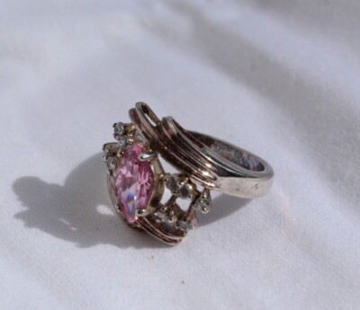 Pink Tourmaline ring surrounded by diamonds on a silver band; Gaudy and comfy 
