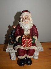 Vintage 2-Piece Christmas Santa Claus Sitting On Bench With A Present