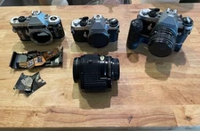 Partially functioning Pentax ME F cameras with AF lens, f1.4 lens, accessories