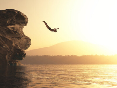 Wandbild: Der junge Mann springt in einen See. Dies ist eine [...]