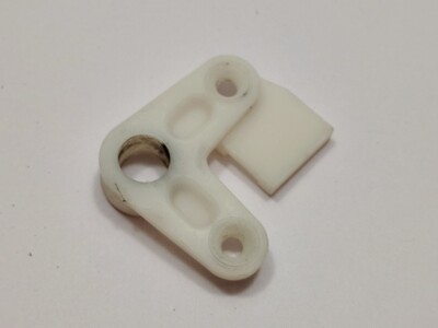 Genuine BMW E30 Door latch. White plastic L-shaped lever. Driver. Front