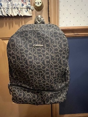 Calvin Klein monogram backpack in a brown and black  CK  pattern with gold-tone