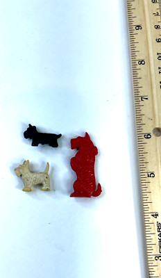 Three Small Plastic Scotties - 1 red plastic, 1 black metal, and 1 white plastic