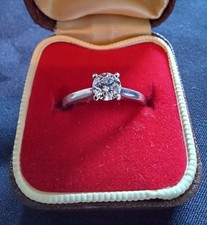 Platinum diamond solitaire engagement ring and platinum wedding ring.