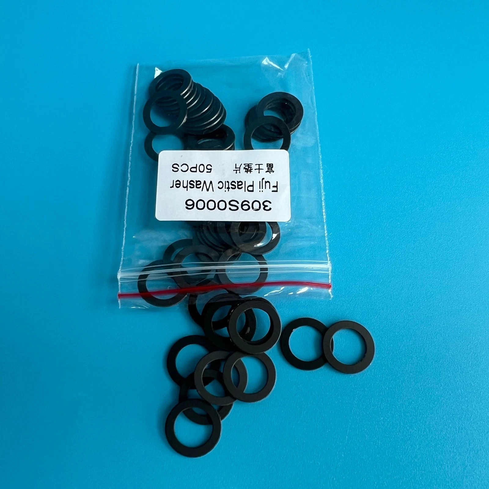 Clear plastic washer C-ring 309S0006 in clear bag with red and white label reading “Fuji Plastic Washer.”