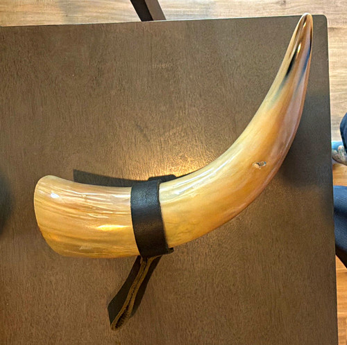 Polished Curved hollowed out horn with a leather strap