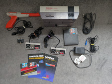 Nintendo NES console with controllers, zapper and original game cartridge