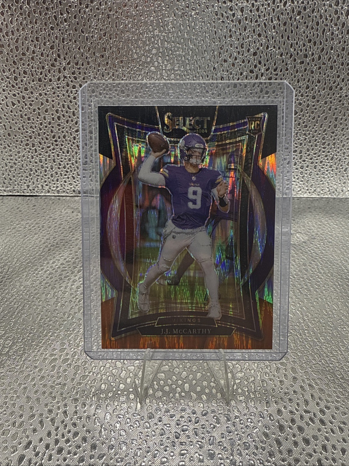 2024 Panini Select - Concourse J.J. McCarthy #24 Black & Orange Shock Prizm (RC)