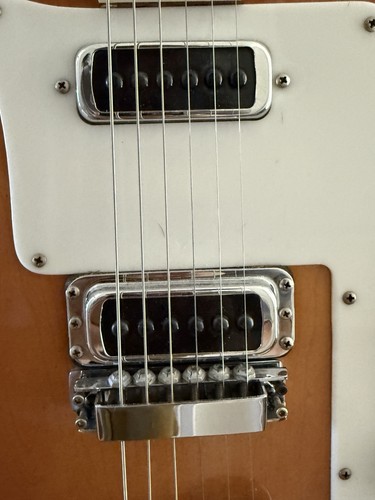 White 1981 Rickenbacker 480 Autumnal glow with black pickguards and silver hardware on a light wood body.