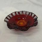 This vintage Fenton Amberina Basket Weave tri-footed bowl.