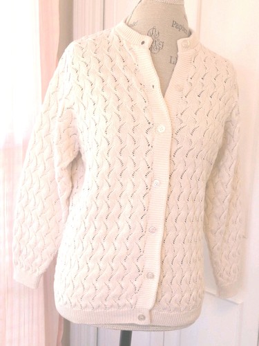 White cotton knit women's long sleeve sweater with scalloped lace pattern, button front, and two front pockets.