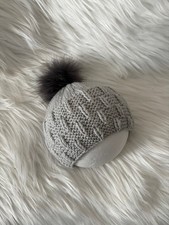 Hand knitted baby beanie hat, sizes 3-6 months, with fluffy faux fur pompom