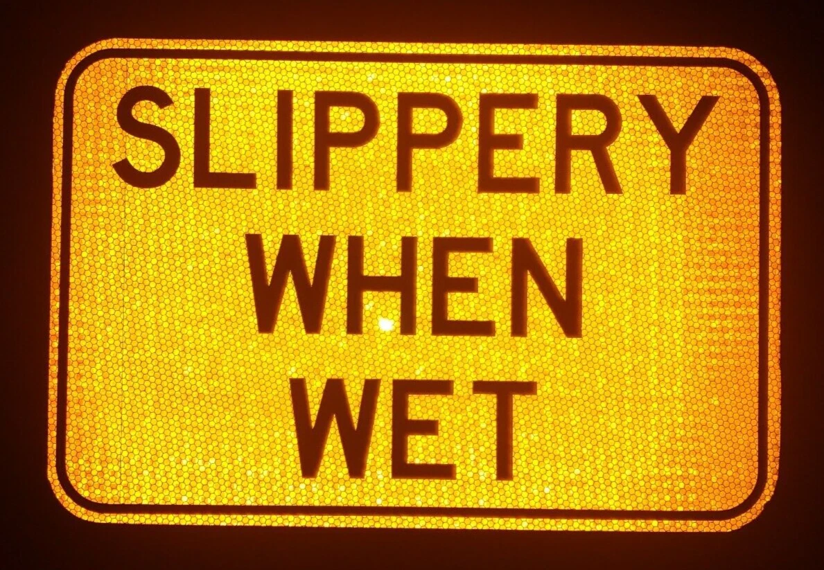 Slippery When Wet Road Sign