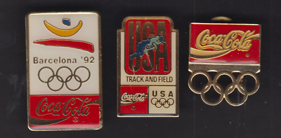 Drei  Coca Cola Anstecker Olympia
