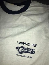 VTG 80S 1984 CHEERS CAFE PUB WE'RE NOT SHOT YET 5TH YEAR RINGER BOSTON SHIRT